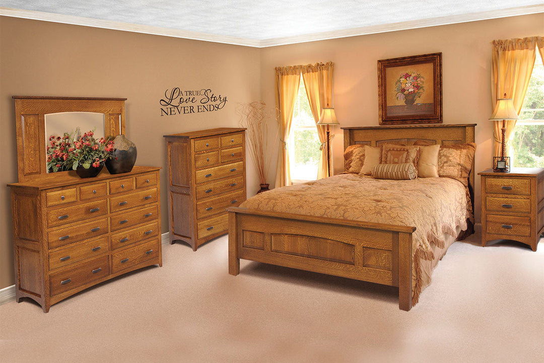 Wooden bedroom furniture set including a bed, dresser, and mirror in a room with beige walls and carpet.